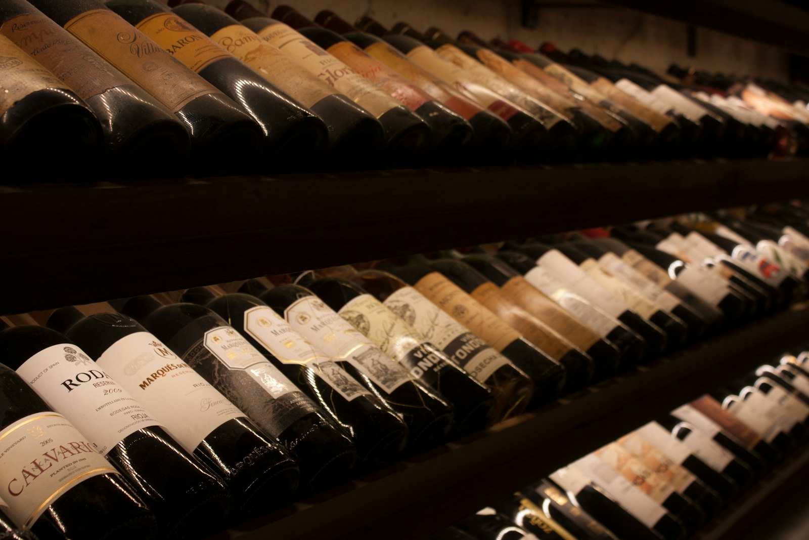 A shelf of California red wine bottles