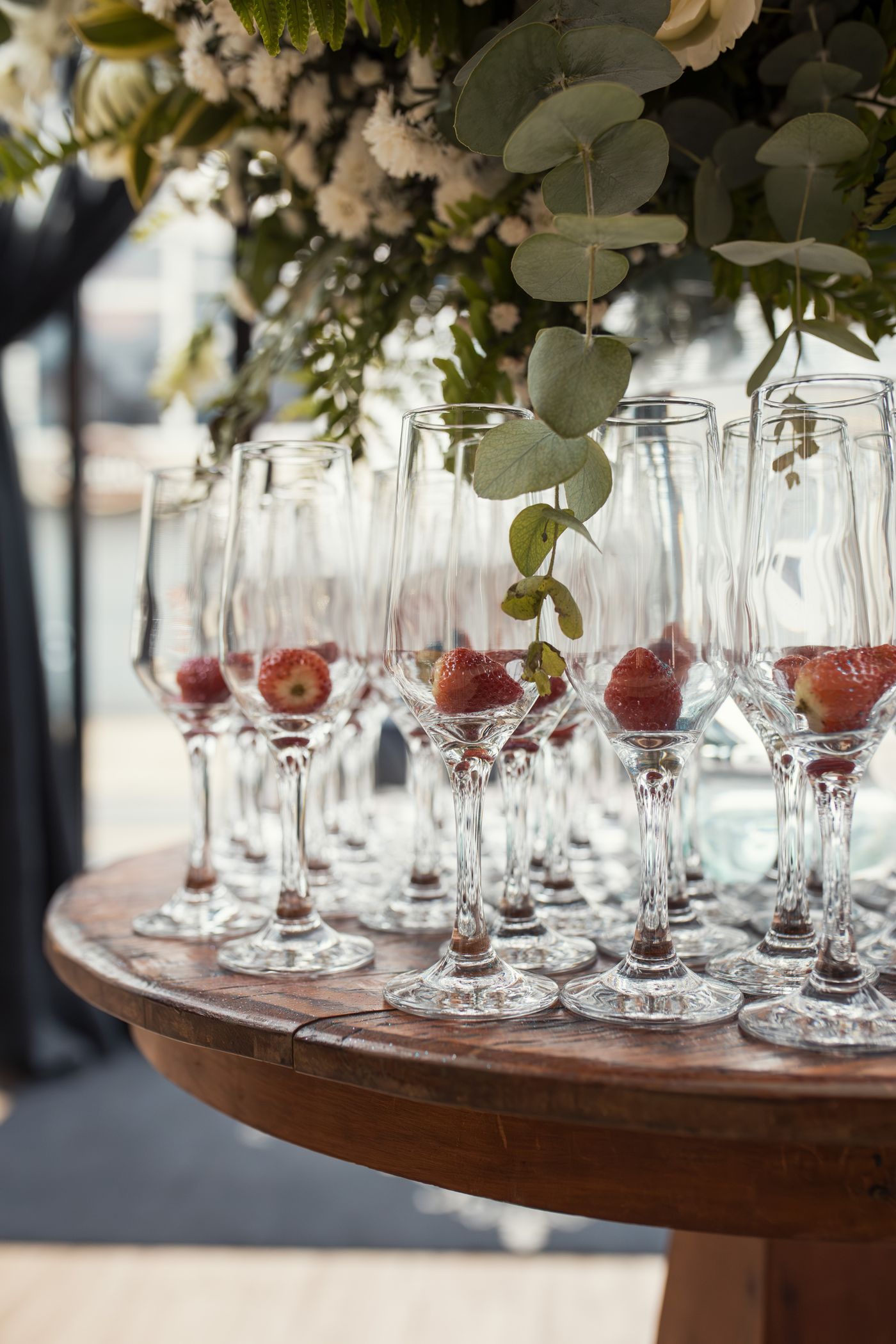Rows of poured red and white wine glasses on a wedding reception bar