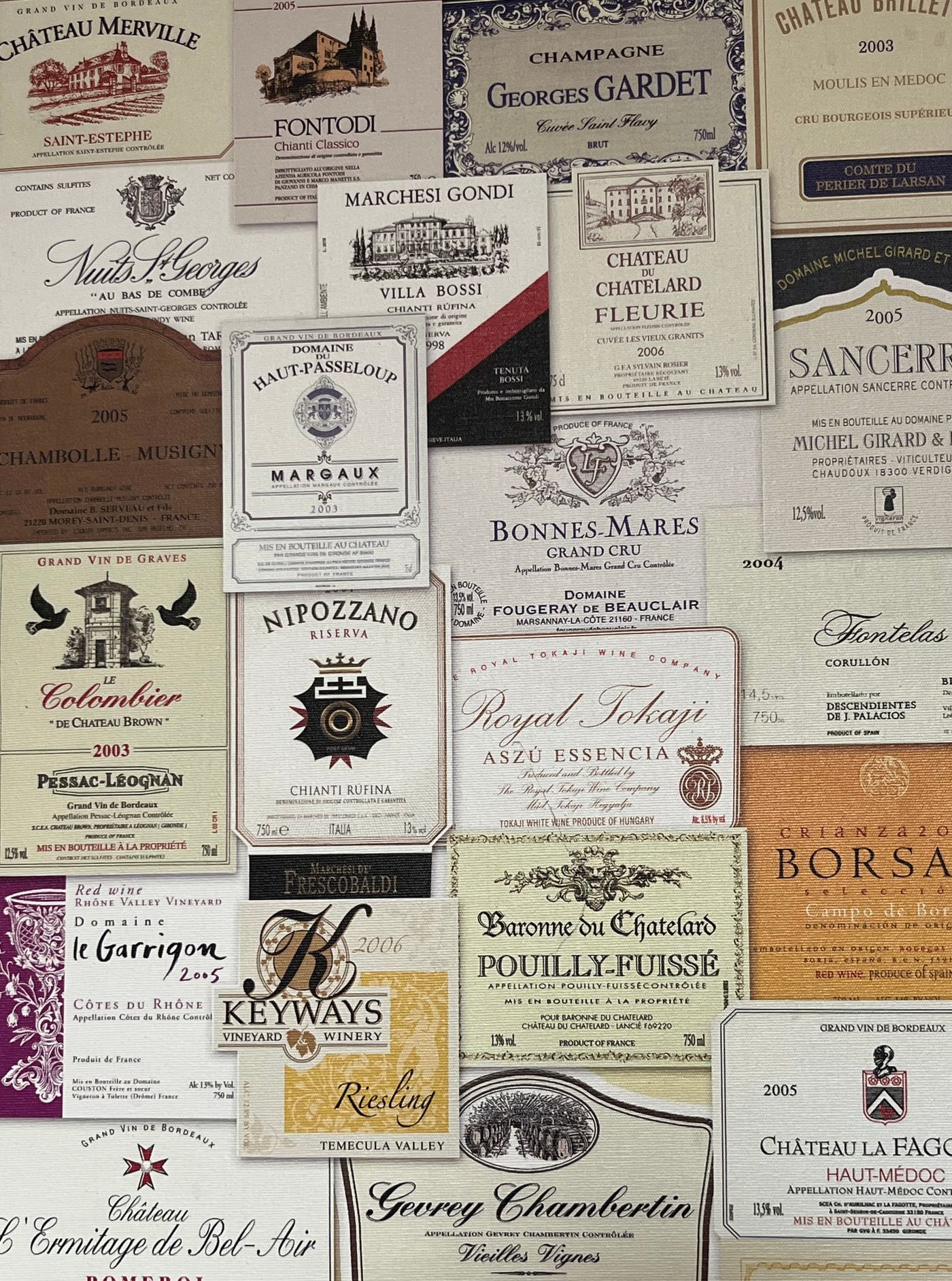 Close-up of French wine labels showing appellation, vintage, and producer