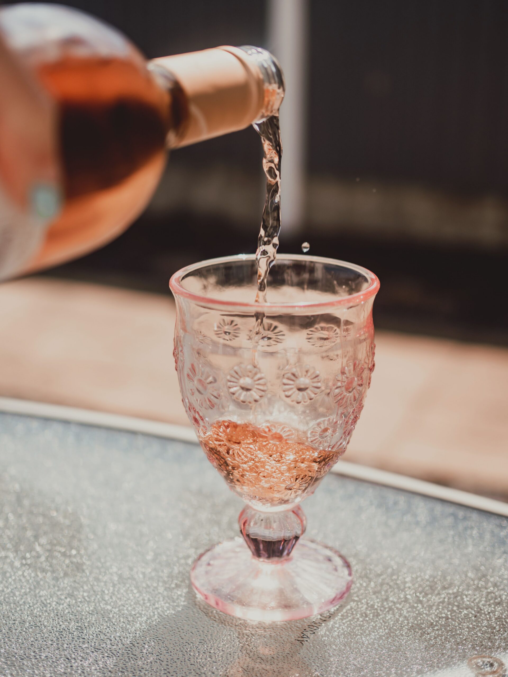 Pink Moscato being poured into a glass, showing its sweet rose style