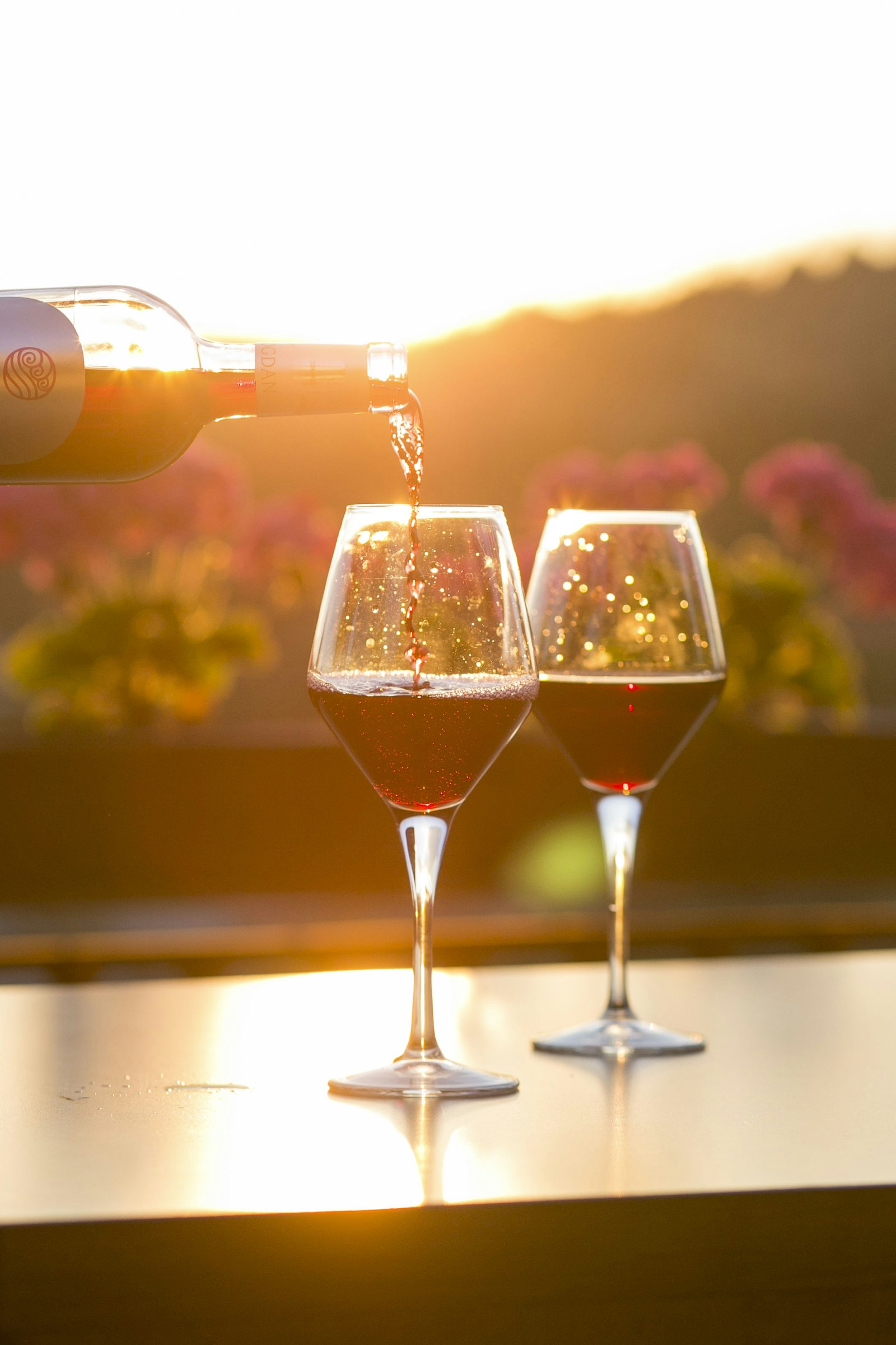 Two glasses of pink wine catching the light at golden hour
