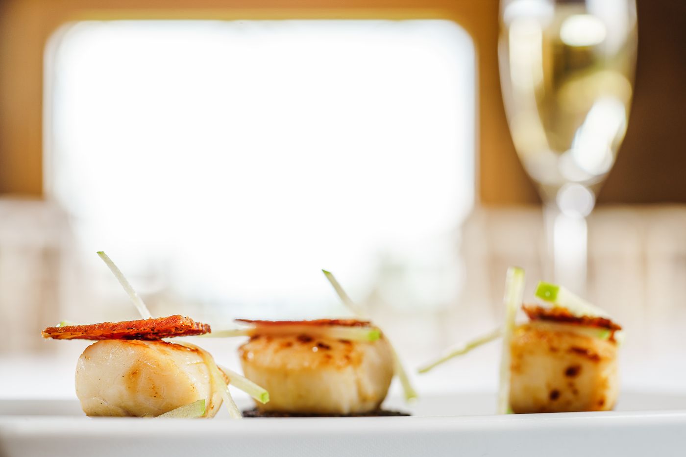 Seared scallops plated with white wine for a romantic seafood dinner at home