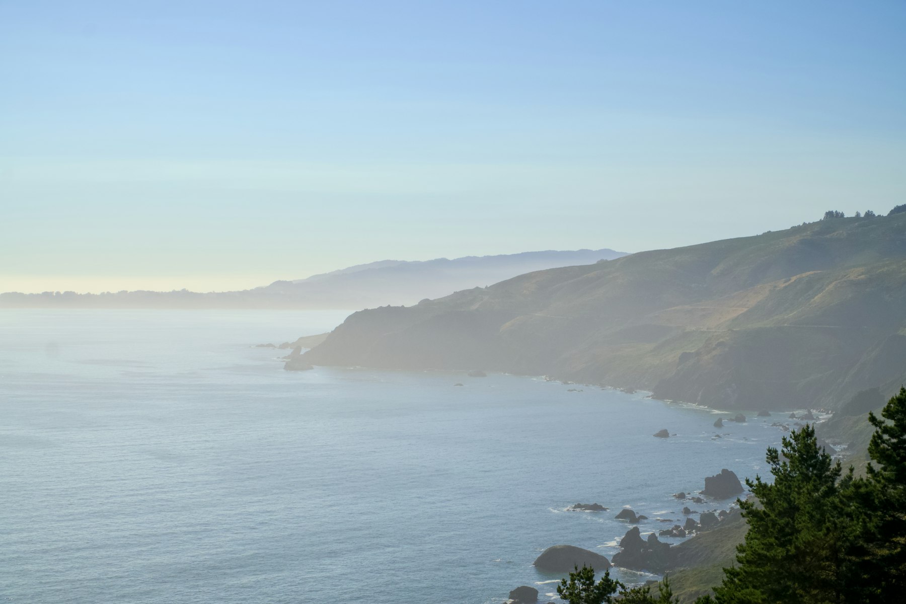 Fog drifting over coastal hills and the ocean on California Central Coast