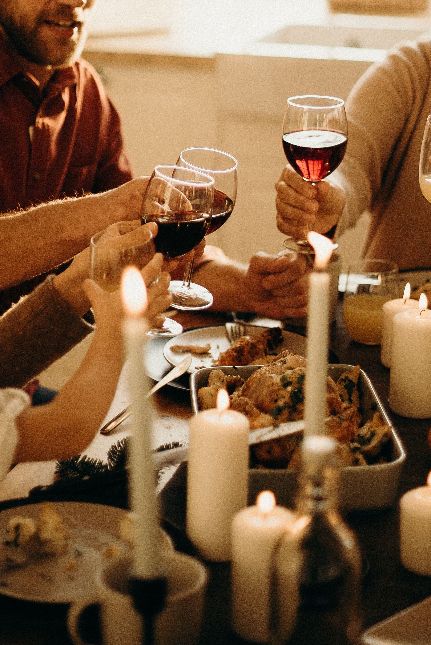 Glasses of red, white, and sparkling wine poured for a holiday turkey dinner