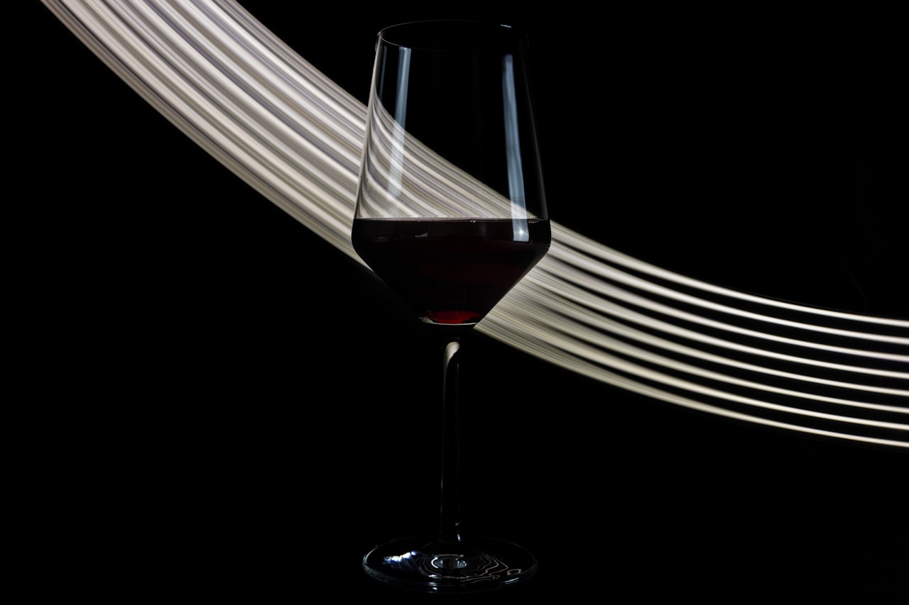 A person swirling a glass of red wine to learn how to taste it