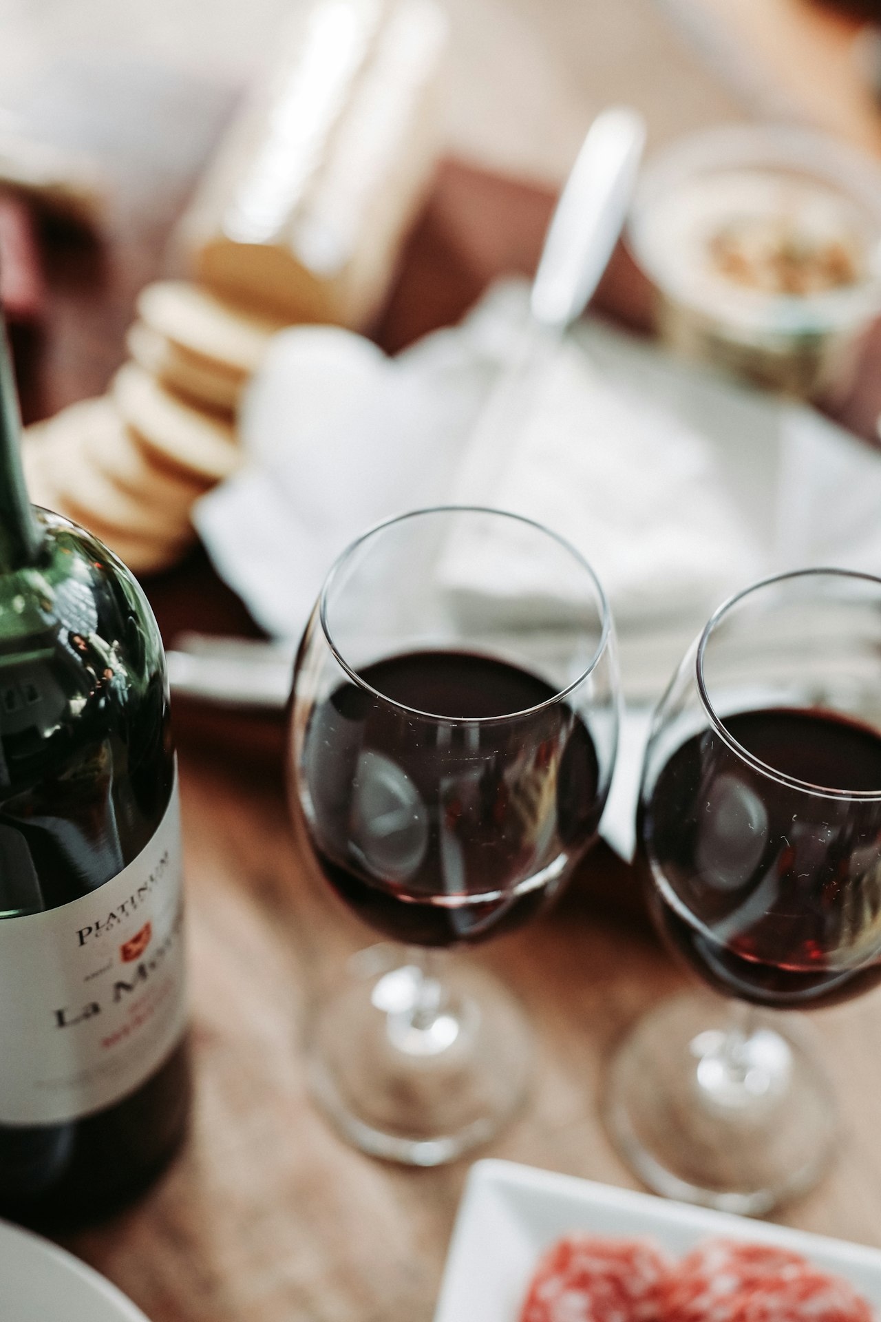 A beginner-friendly flight of red and white wine in glasses on a wooden table