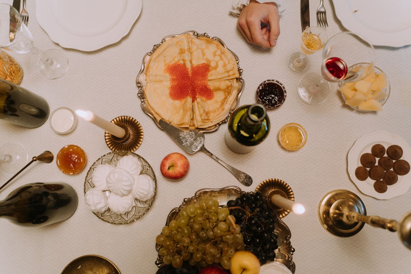 Overhead spread of food and wine showing steak, salmon, cheese, and several glasses of red and white wine arranged for pairing
